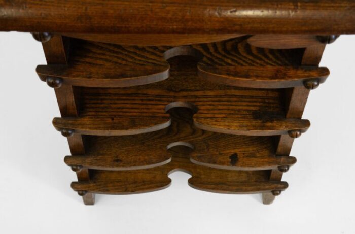 american arts crafts oak paper rack in the style of charles rohlfs 1900s 2